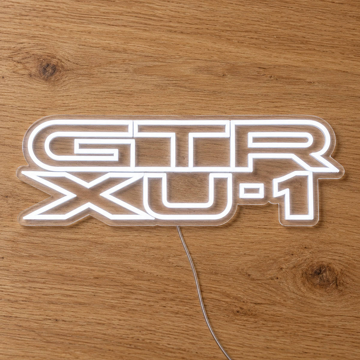 Holden Torana GTR-XU1 LED Neon Sign in white, featuring stacked GTR XU-1 lettering on a wooden surface.