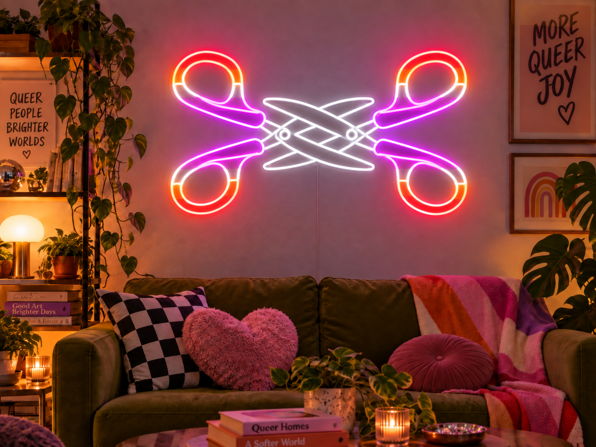 Scissoring Lesbian Queer Neon Sign in pink, orange and white, featuring two crossing pairs of scissors above a colourful sofa.