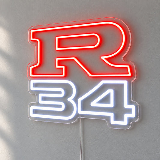 Nissan R34 LED Neon Sign in red and white, featuring R34 lettering on a grey wall.