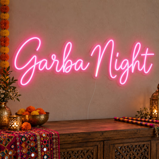 Garba Night Neon Sign on clear cut-to-shape acrylic, illuminated on a wall in a styled celebration setting