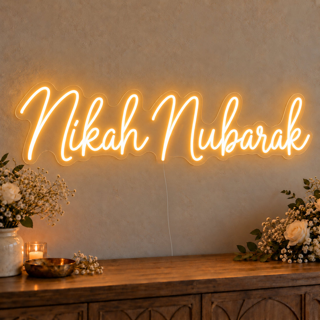 Nikah Mubarak Neon Sign on clear cut-to-shape acrylic, illuminated on a wall in a styled celebration setting