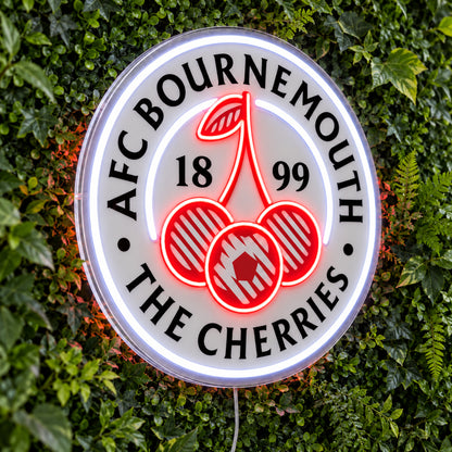 AFC Bournemouth LED Neon Sign, featuring team logo displayed on a green foliage wall.