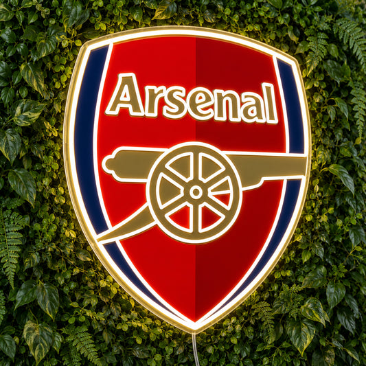 Arsenal LED Neon Sign, featuring team logo displayed on a green foliage wall.