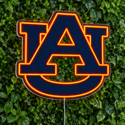 Auburn Tigers LED Neon Sign, featuring team logo displayed on a green foliage wall.
