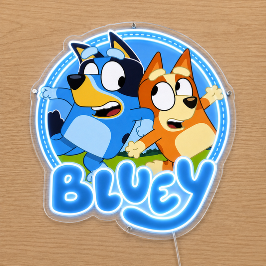 A circular acrylic LED neon sign featuring the Bluey characters Blue and Bingo with the word 'BLUEY' in large glowing blue letters, mounted on a light wood surface.