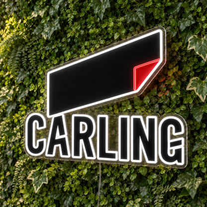 Carling LED Neon Sign, featuring beer-brand logo displayed on a green foliage wall.