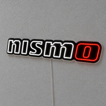 Nissan Nismo LED Neon Sign in white and red, featuring Nismo lettering on a grey wall.