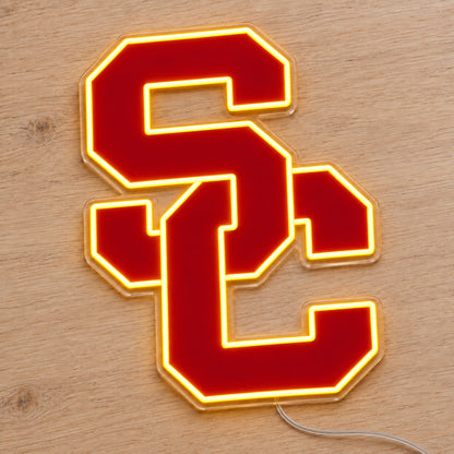 USC Trojans LED Neon Sign, featuring team logo displayed on a wooden surface.