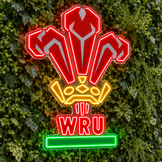Wales Rugby LED Neon Sign, featuring team logo displayed on a green foliage wall.
