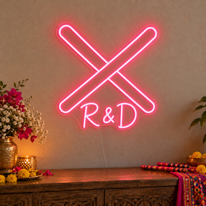 Personalised Dandiya Initials Neon Sign on clear cut-to-shape acrylic in an illuminated wall display; example personalisation shown.