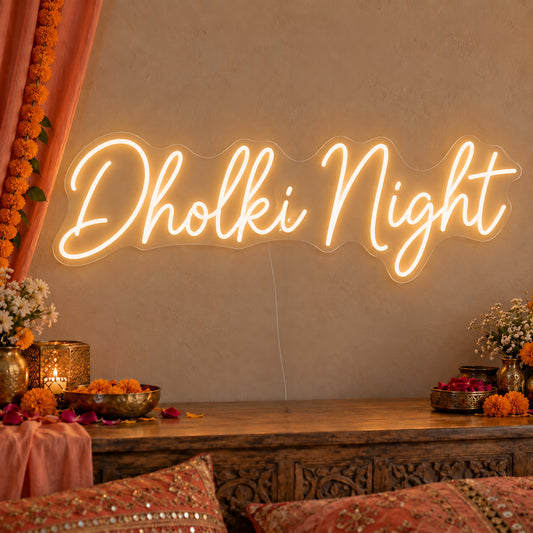 Dholki Night Neon Sign on clear cut-to-shape acrylic, illuminated on a wall in a styled celebration setting