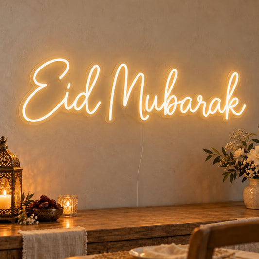 Eid Mubarak Neon Sign on clear cut-to-shape acrylic, illuminated on a wall in a styled celebration setting