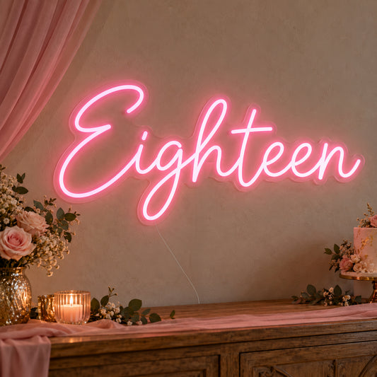 Eighteen Neon Sign on clear cut-to-shape acrylic, illuminated on a wall in a styled celebration setting