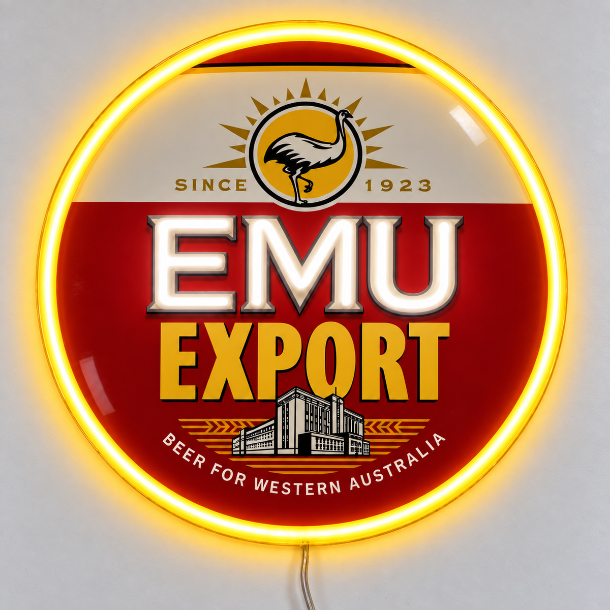 Emu Export Neon Sign with white EMU lettering, yellow neon border and UV-printed beer logo on clear acrylic, lying on a white table.