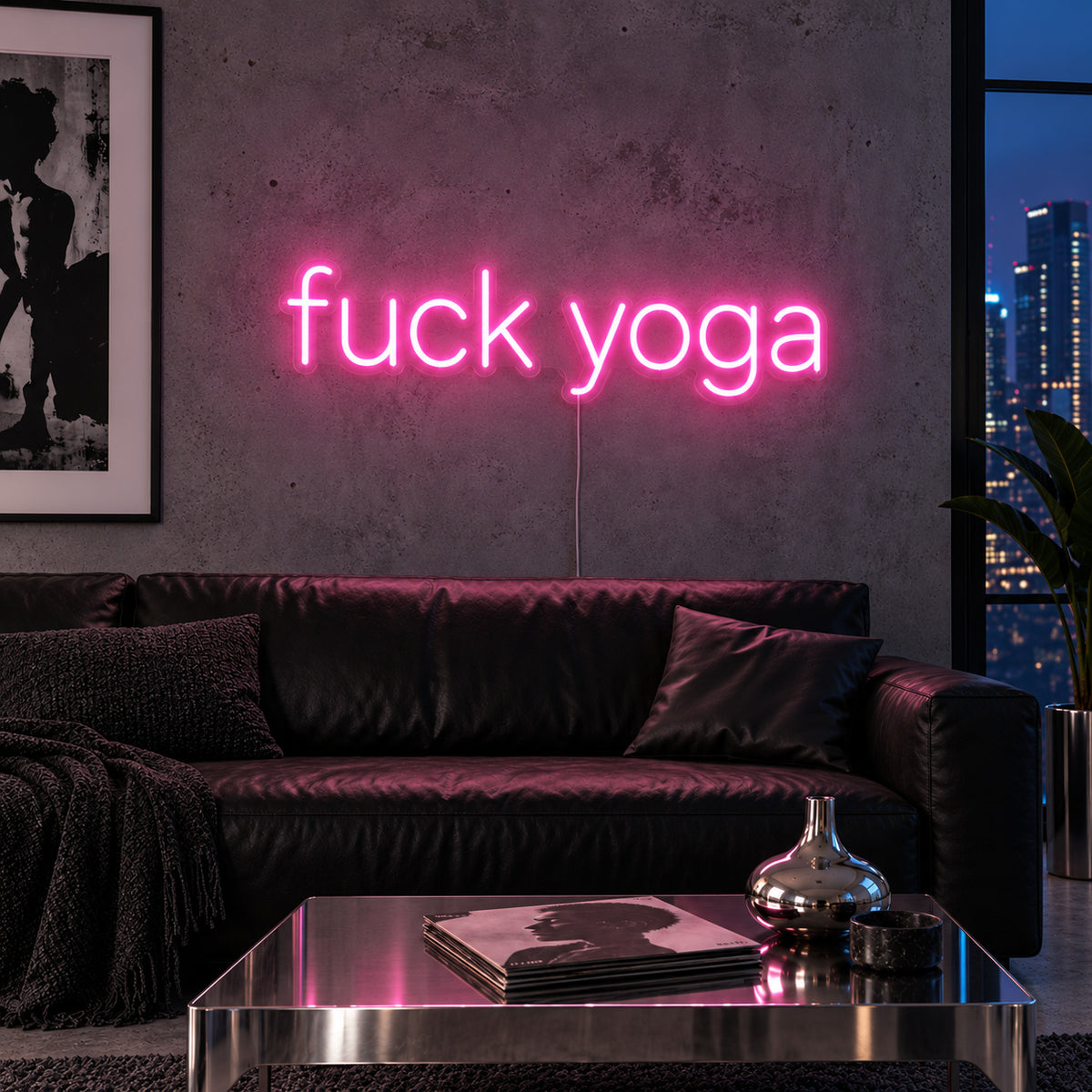 Fuck Yoga Neon Sign glowing pink above a black leather sofa.