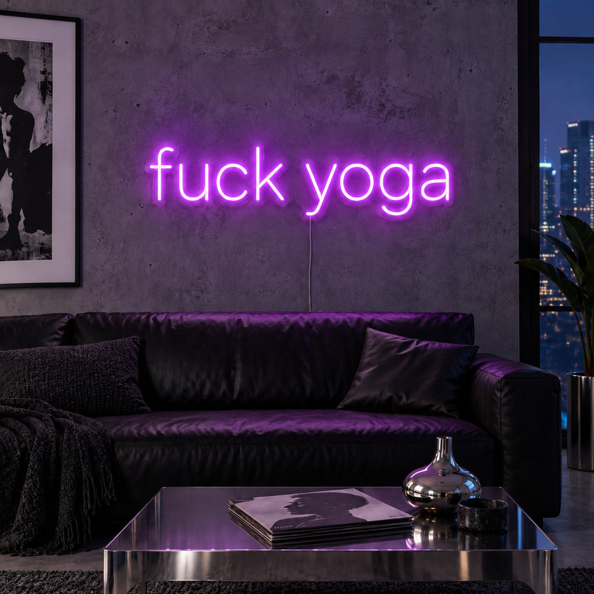Fuck Yoga Neon Sign with purple lighting, displayed above a black leather sofa.