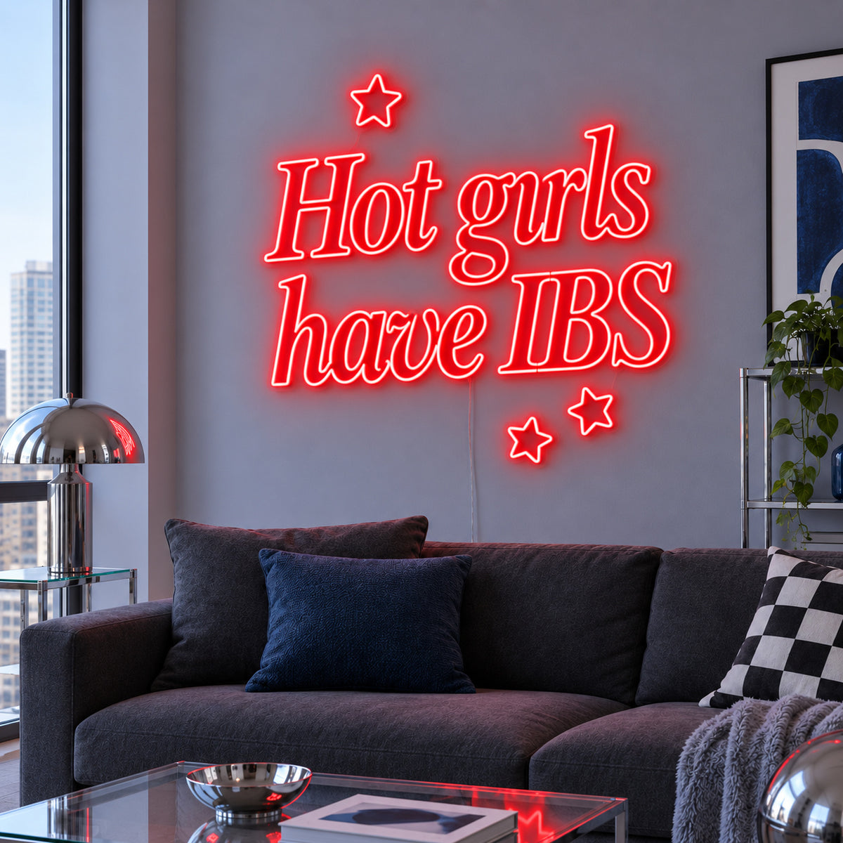 Hot Girls Have IBS Neon Sign with red lighting, displayed with star details above a charcoal sofa.
