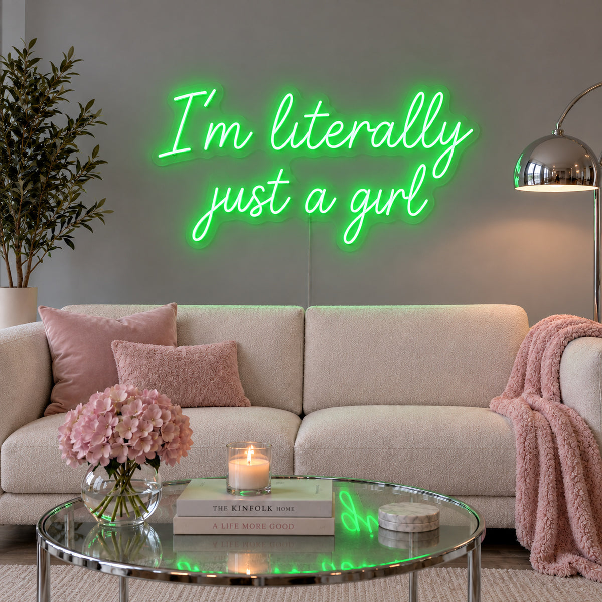 I'm Literally Just A Girl Neon Sign with green lighting, displayed above a cream sofa.