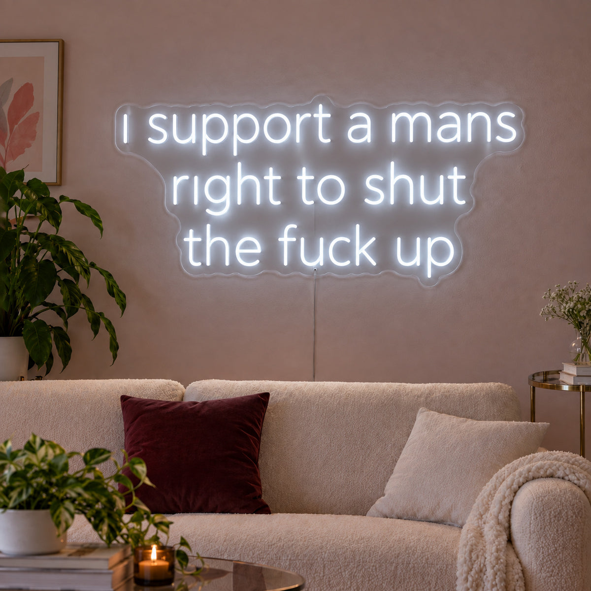 I Support A Mans Right To Shut The Fuck Up Neon Sign, RGB colour-changing option shown in white above a cream sofa.