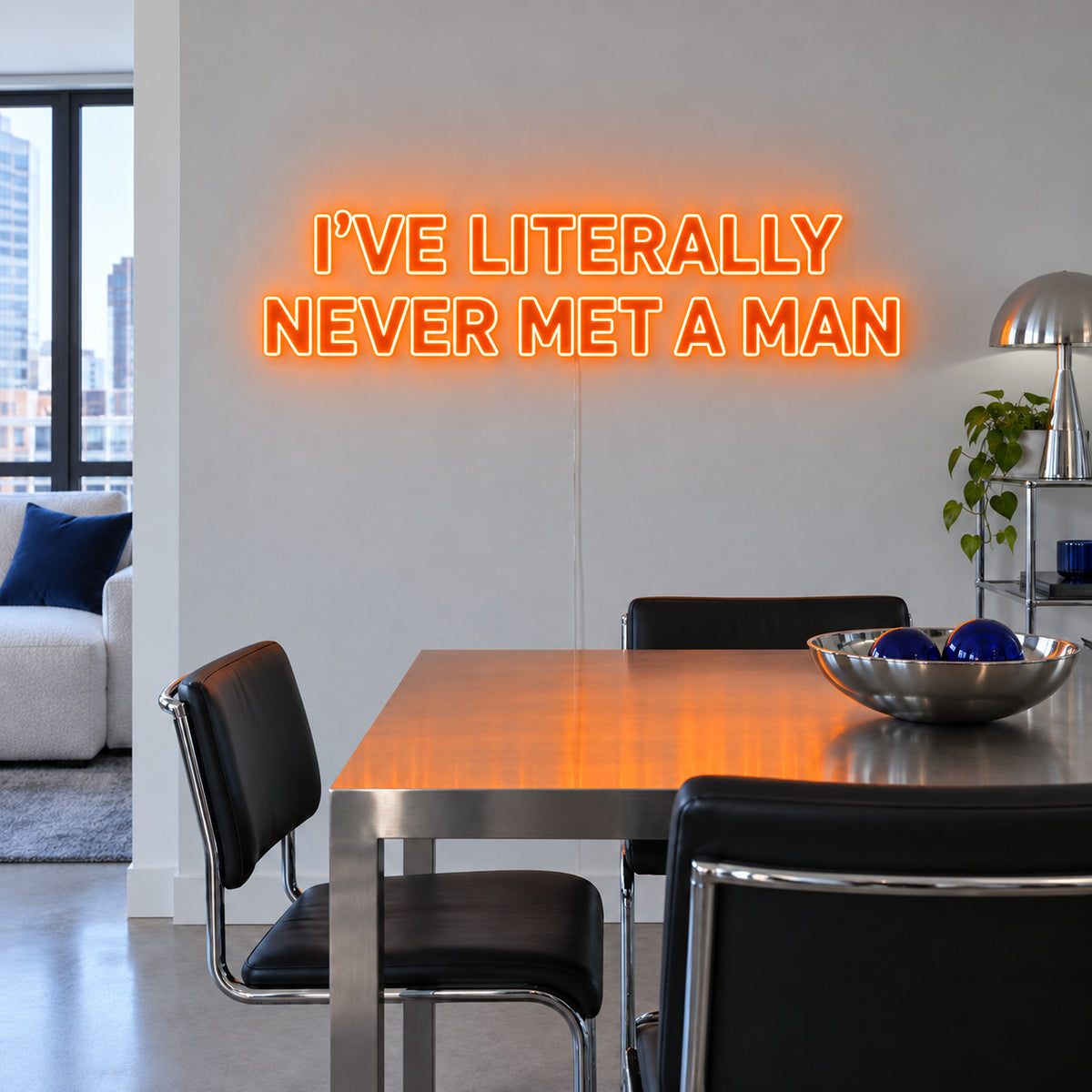 Orange version of the I've Literally Never Met A Man Neon Sign, shown above a dining table.