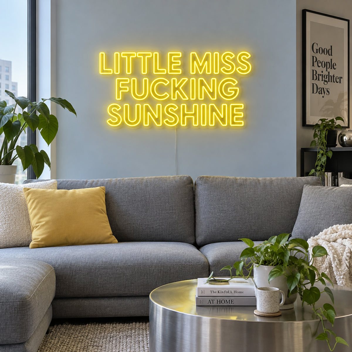 Little Miss Fucking Sunshine Neon Sign in yellow above a grey sofa with yellow cushions.