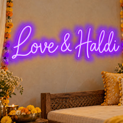 Love Haldi Neon Sign in purple LED neon on clear acrylic, angled view