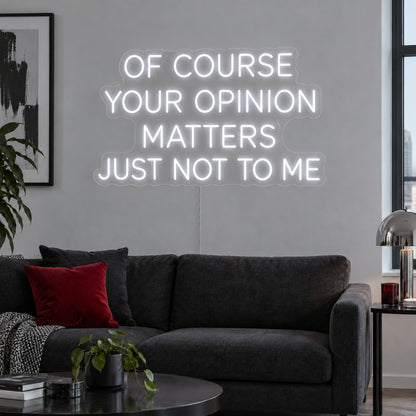 Of Course Your Opinion Matters Just Not To Me Neon Sign in white above a black sofa.