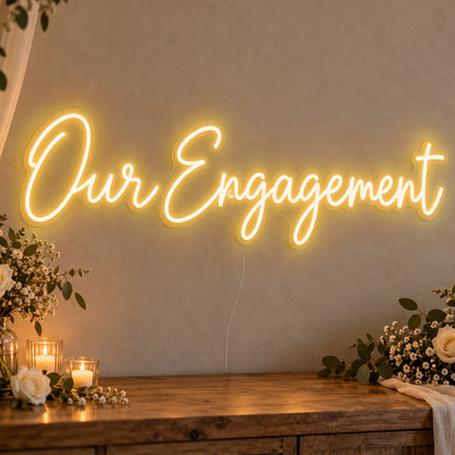 Our Engagement Neon Sign in gold LED neon on clear acrylic, angled view