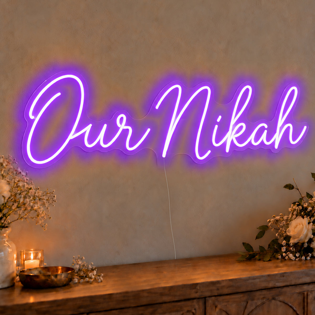 Our Nikah Neon Sign in purple LED neon on clear acrylic, angled view