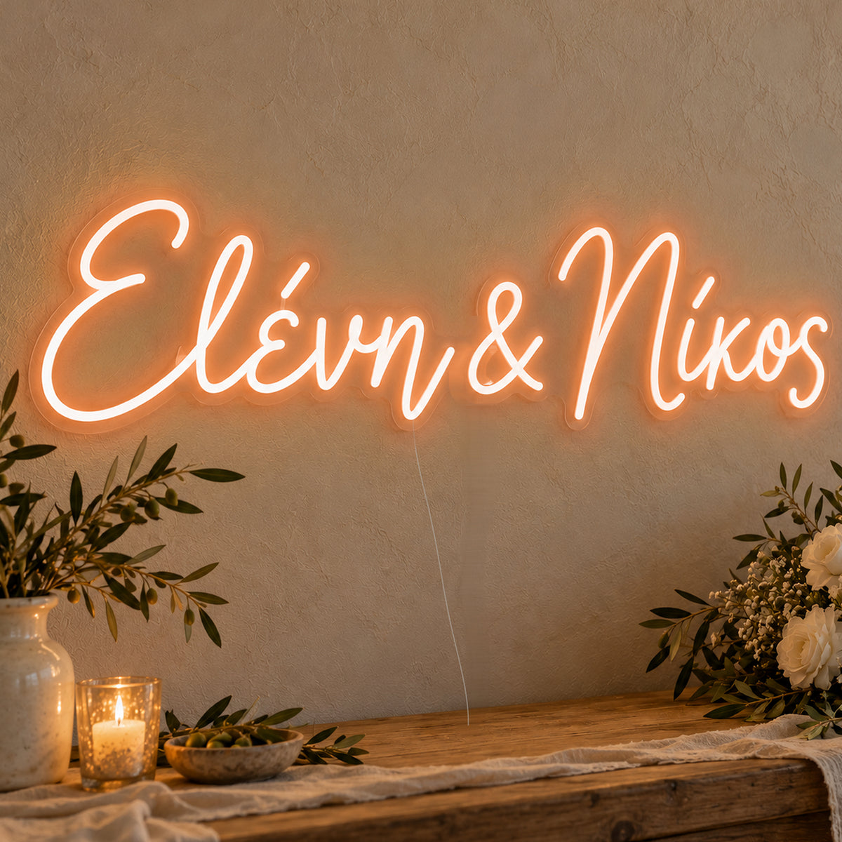 Personalised Greek Couple Names Neon Sign in orange LED neon on clear acrylic, angled view