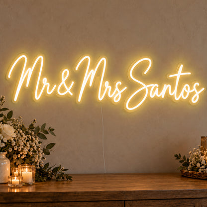 Personalised Mr & Mrs Surname Neon Sign in gold LED neon on clear acrylic, angled view