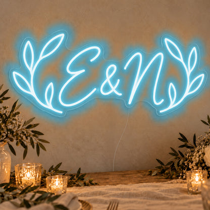 Personalised Olive Initials Neon Sign in ice blue LED neon on clear acrylic, angled view