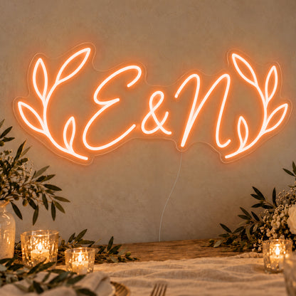 Personalised Olive Initials Neon Sign in orange LED neon on clear acrylic, angled view