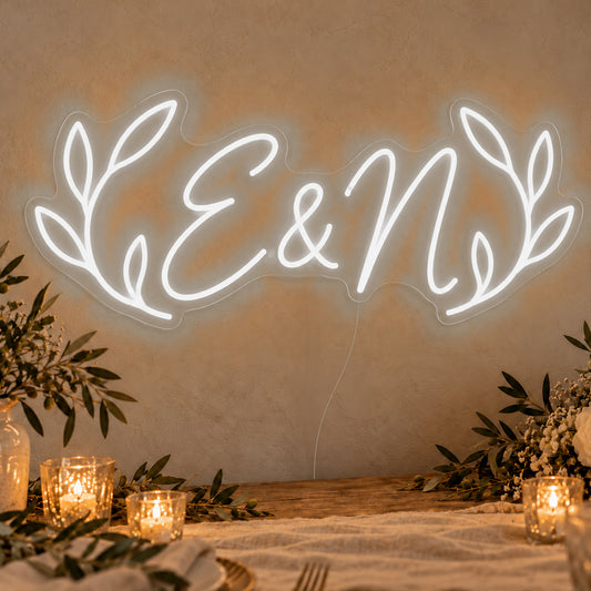 Personalised Olive Initials Neon Sign in white LED neon on clear acrylic, angled view