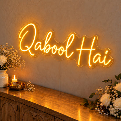 Qabool Hai Neon Sign in gold LED neon on clear acrylic, angled view