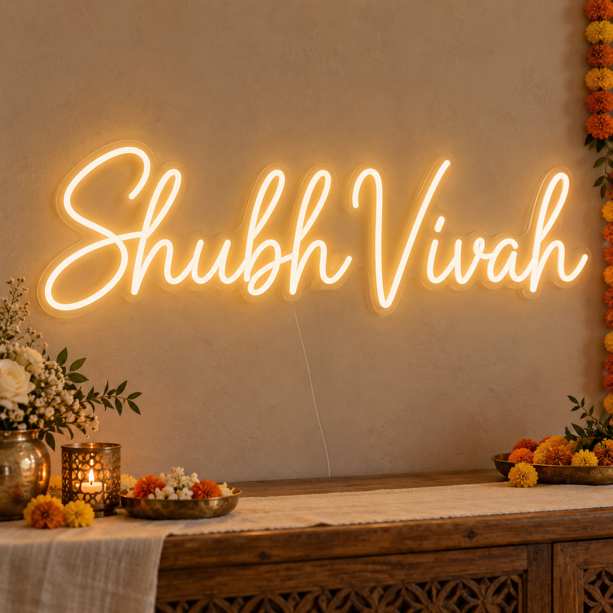 Shubh Vivah Neon Sign on clear cut-to-shape acrylic, illuminated on a wall in a styled celebration setting