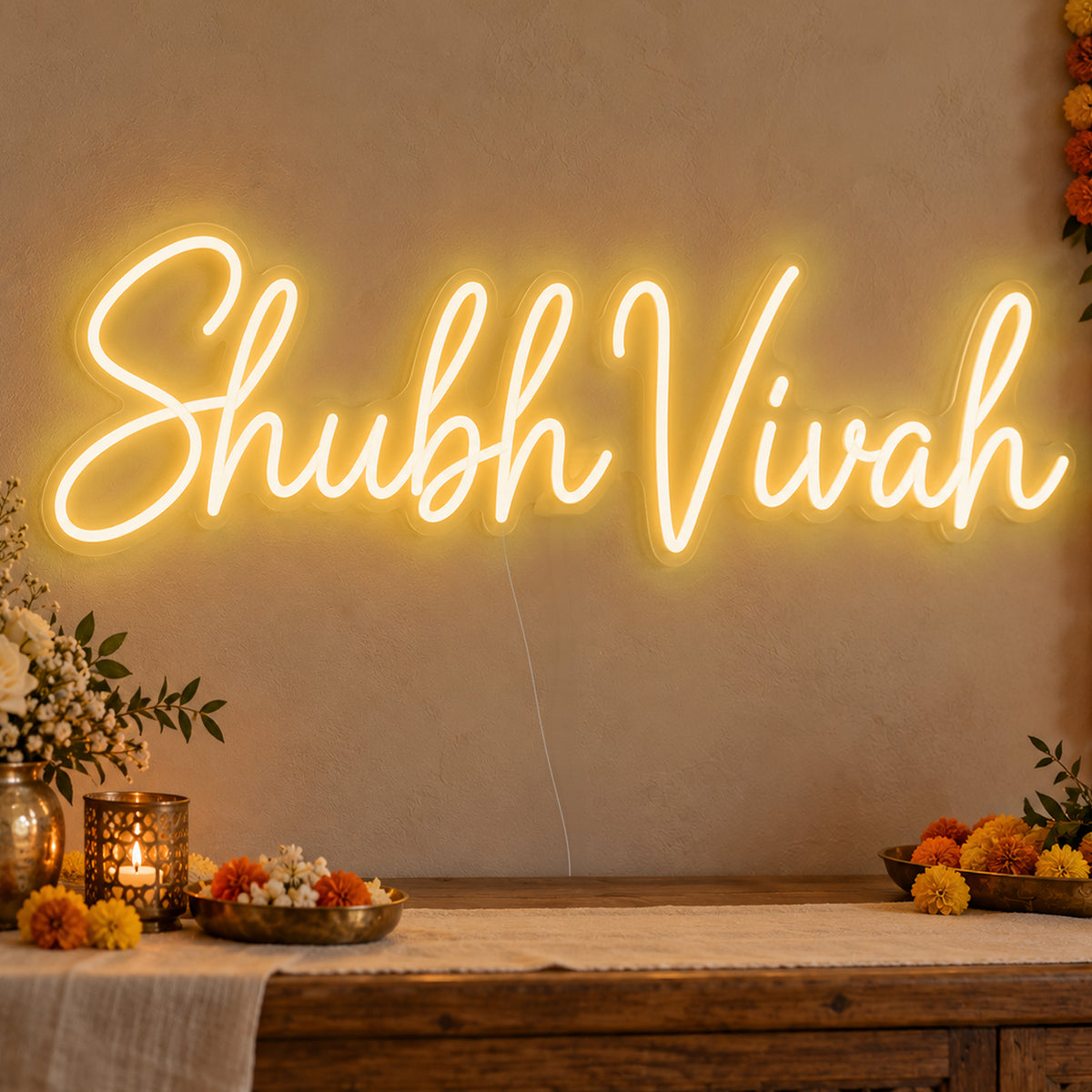Shubh Vivah Neon Sign in gold LED neon on clear acrylic, angled view