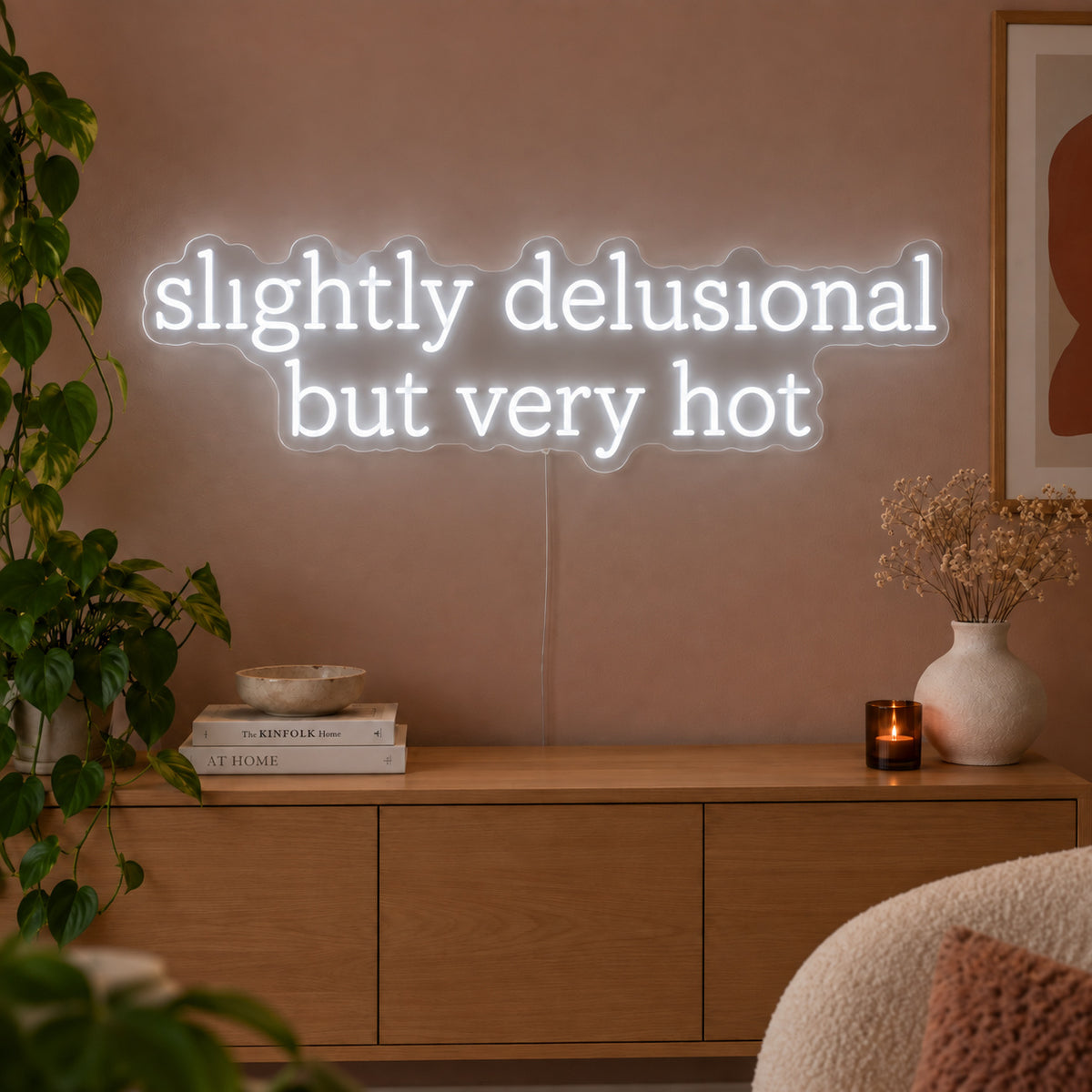 Slightly Delusional But Very Hot Neon Sign, RGB colour-changing option shown in white above a wooden sideboard.