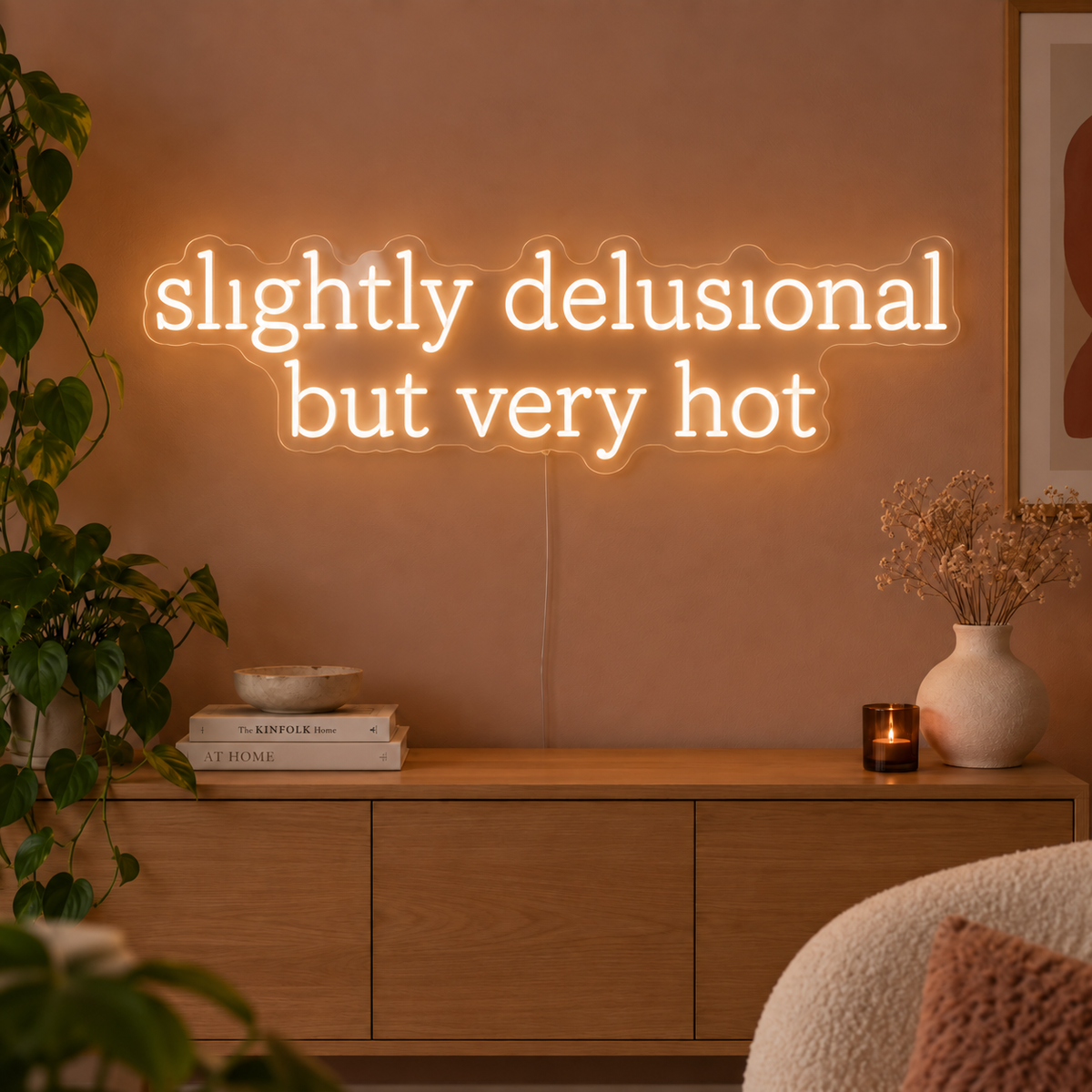 Slightly Delusional But Very Hot Neon Sign in warm white above a wooden sideboard.